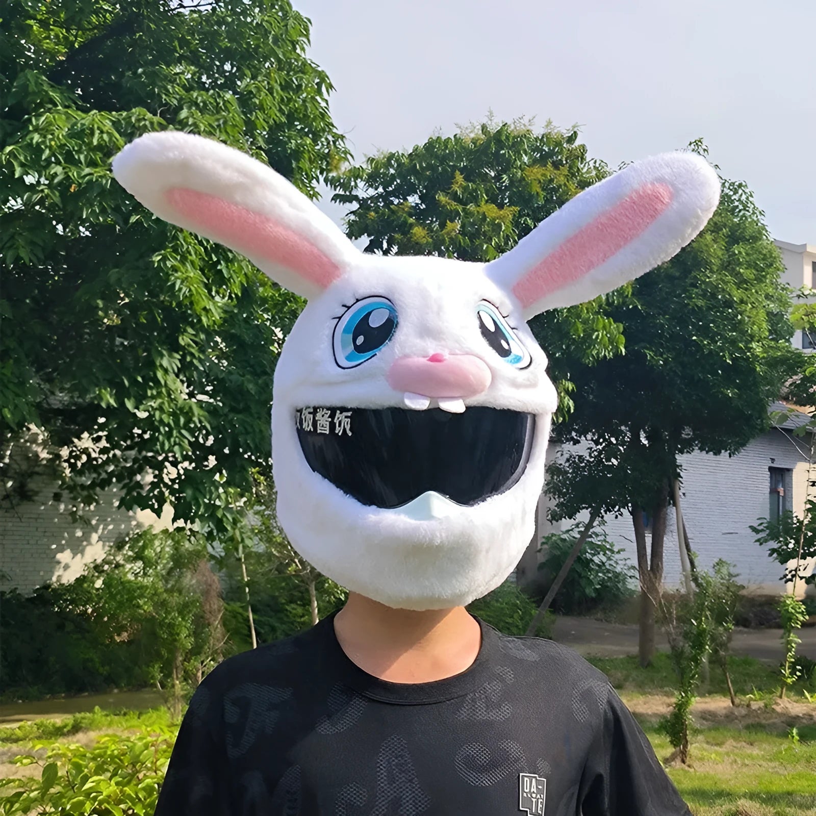 White decorative rabbit head cover for an electric motorcycle helmet with long ears and plush lining.