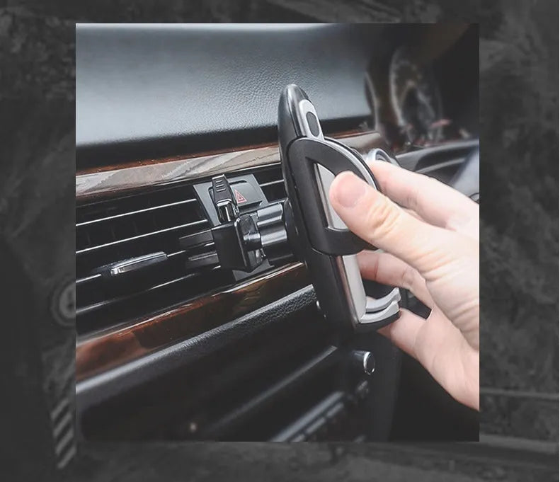 Black plastic universal mobile phone holder mounted on car air vent