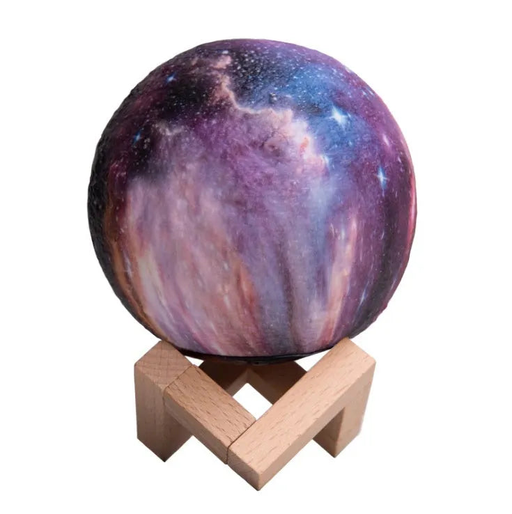 White spherical lunar night light with textured surface and glowing LED illumination on a dark surface.