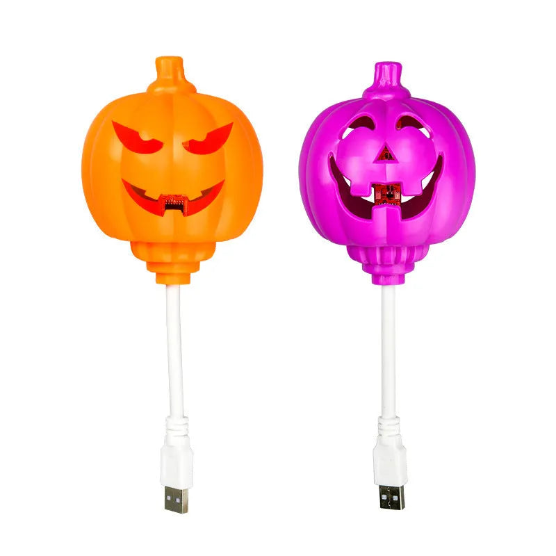 Plastic pumpkin-shaped decorative lamp with a USB cable, glowing either yellow or purple.