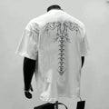 Man wearing a black loose-fit pure cotton short sleeve t-shirt with a printed design.