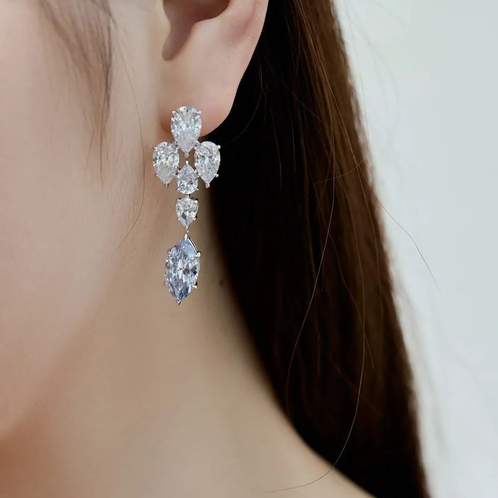 Pair of S925 sterling silver drop-shaped stud earrings with Platinum White Diamond electroplated finish on white background