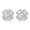 A pair of 925 silver earrings with a four-leaf clover charm and heart-shaped zircon stones in white gold colour.