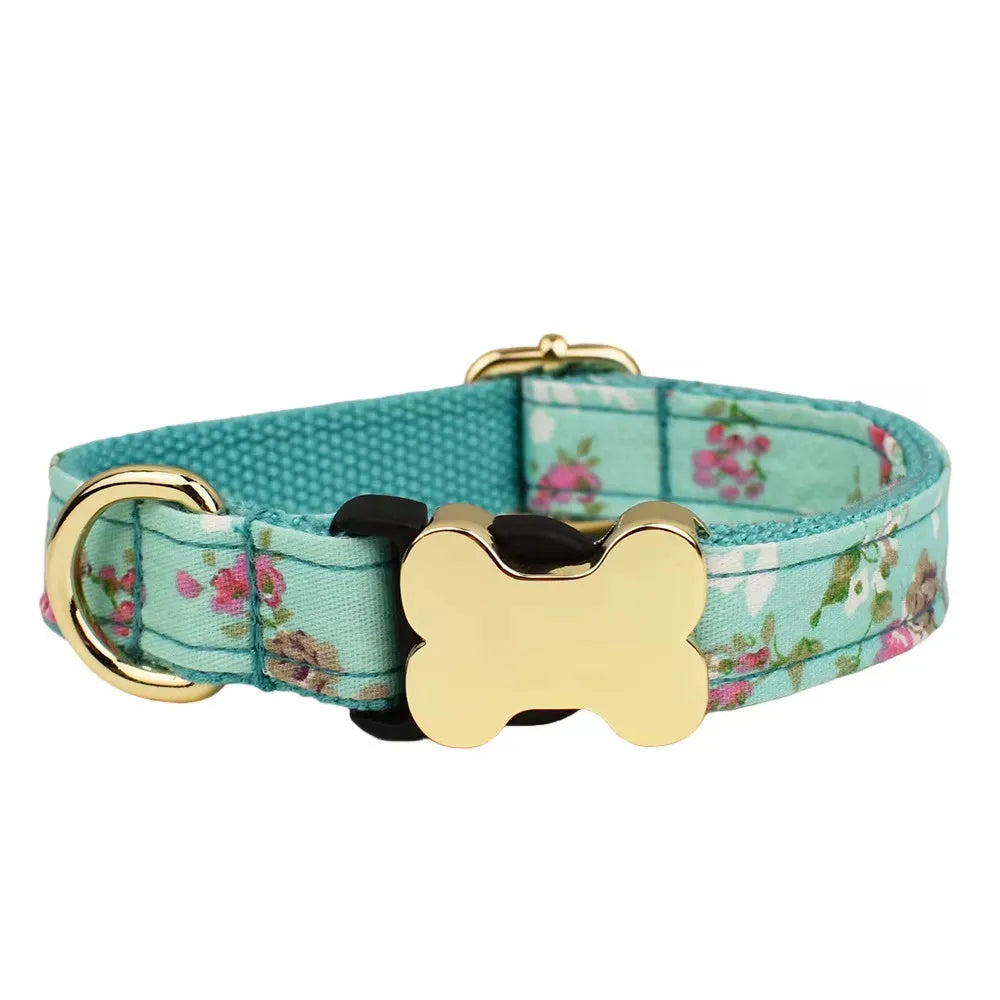 Flat nylon dog collar with a printed grid pattern and a silver bone-shaped metal buckle on a blue background.