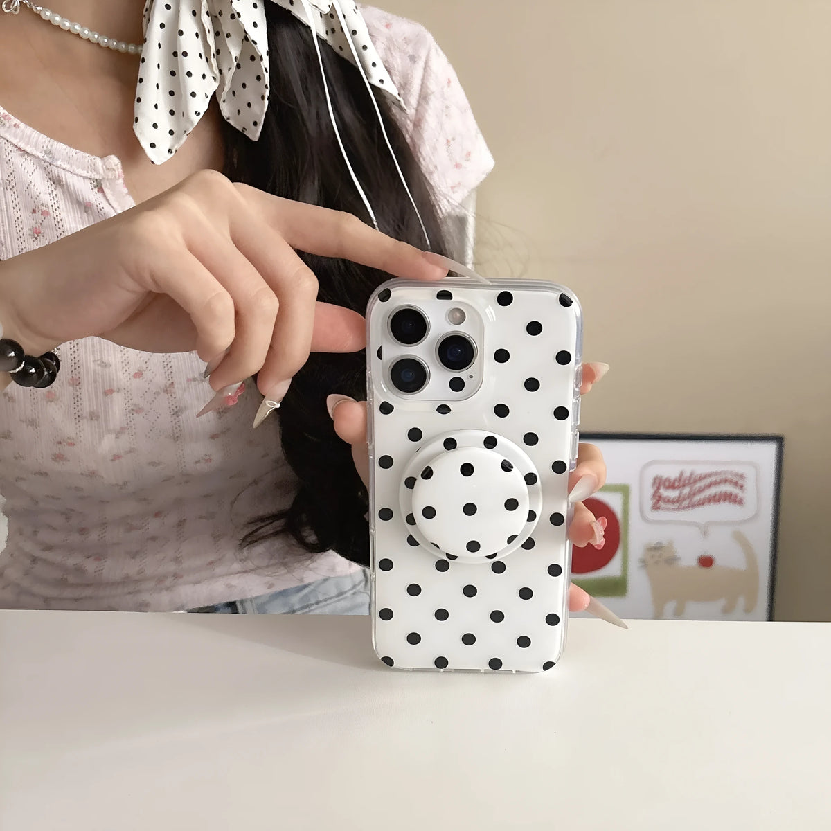 Polka dot iPhone case with magnetic bracket in black, pink, blue, and purple, compatible with iPhone models.