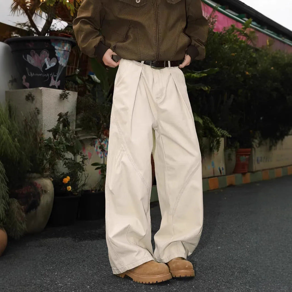 Men's loose straight-leg pleated trousers in apricot stripes on a mid-waist fit model.
