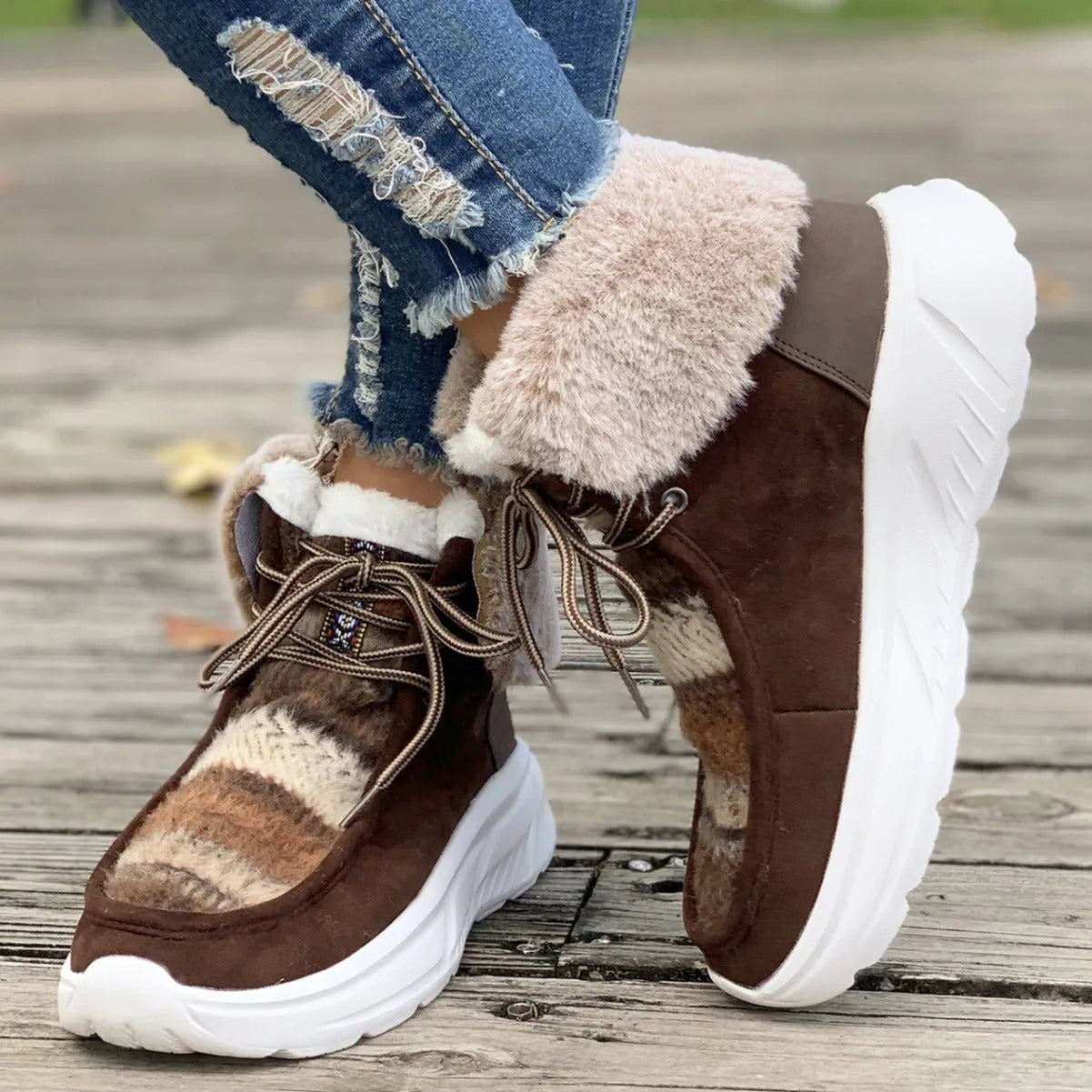 Women's beige lace-up snow boots with suede upper, thick rubber sole, and fuzzy lining.