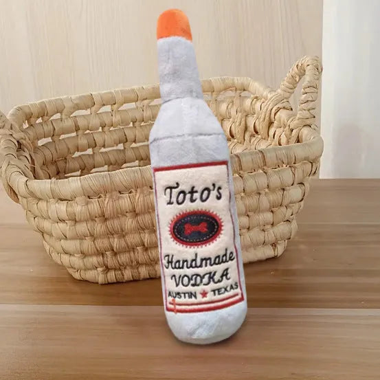 Brown plush wine bottle shaped dog toy with squeaker for chewing and play