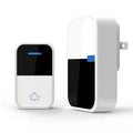 Modern white plastic wireless doorbell receiver and transmitter on a table.