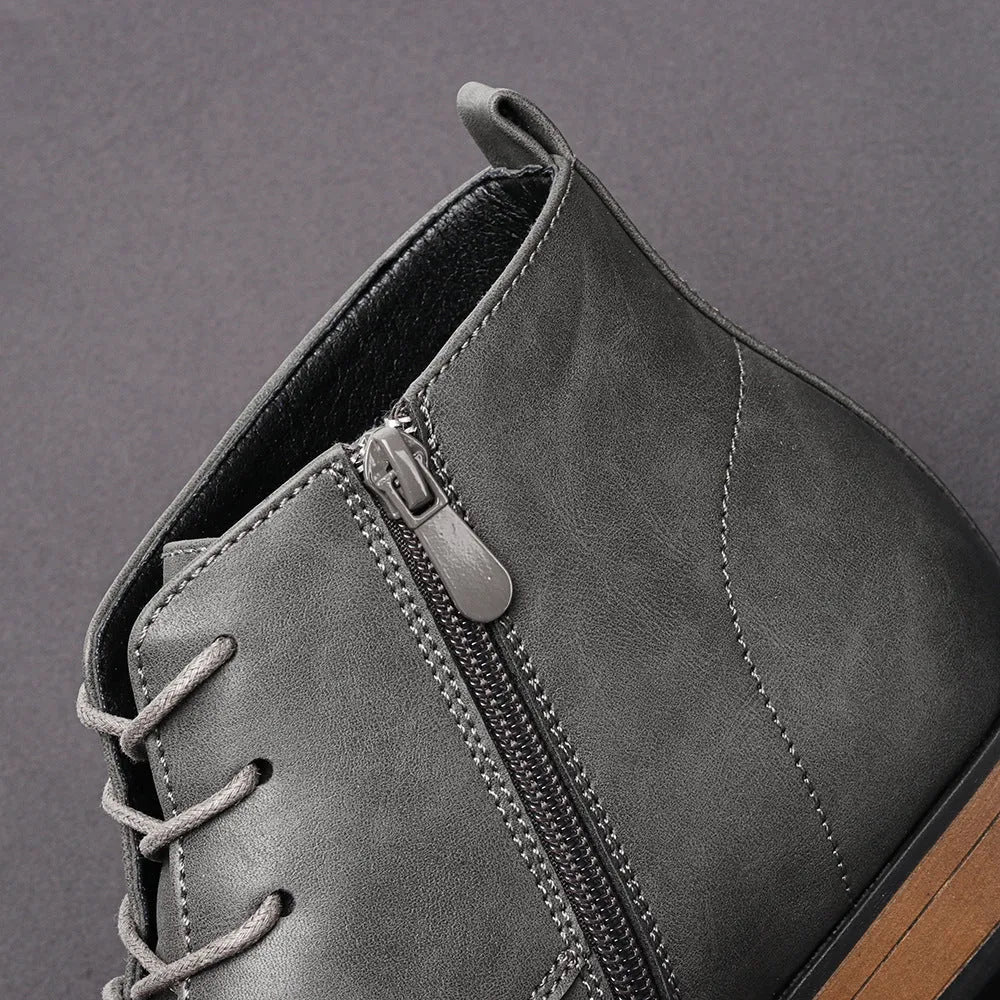 Men's brown Chelsea boot with side zipper, round toe, low heel, and wooden sole.