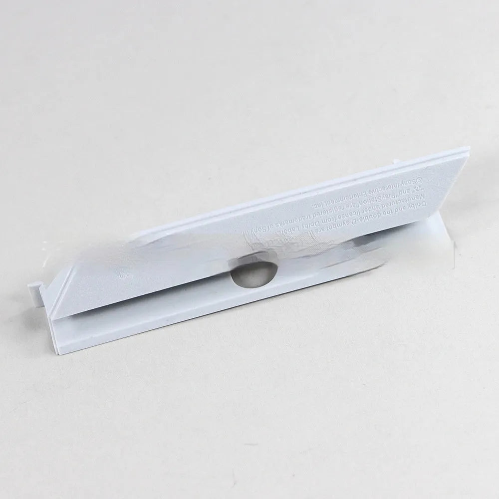 A black plastic hard drive bay cover for a 3.5-inch slot, shown alongside a white version.