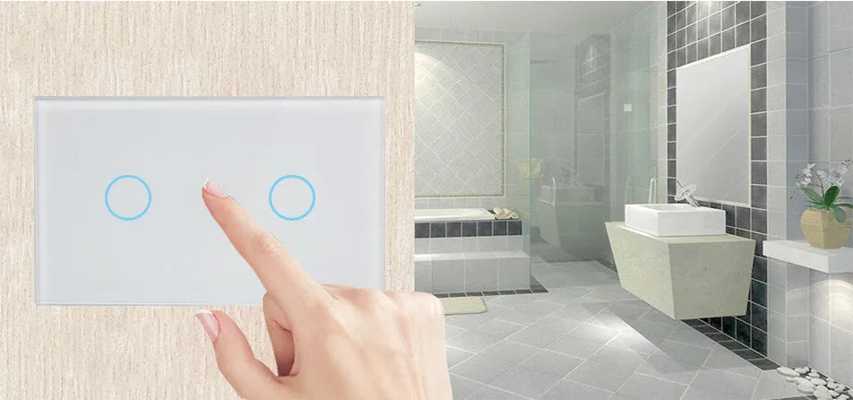 White smart touch light switch with tempered glass panel and silver frame on a wall.