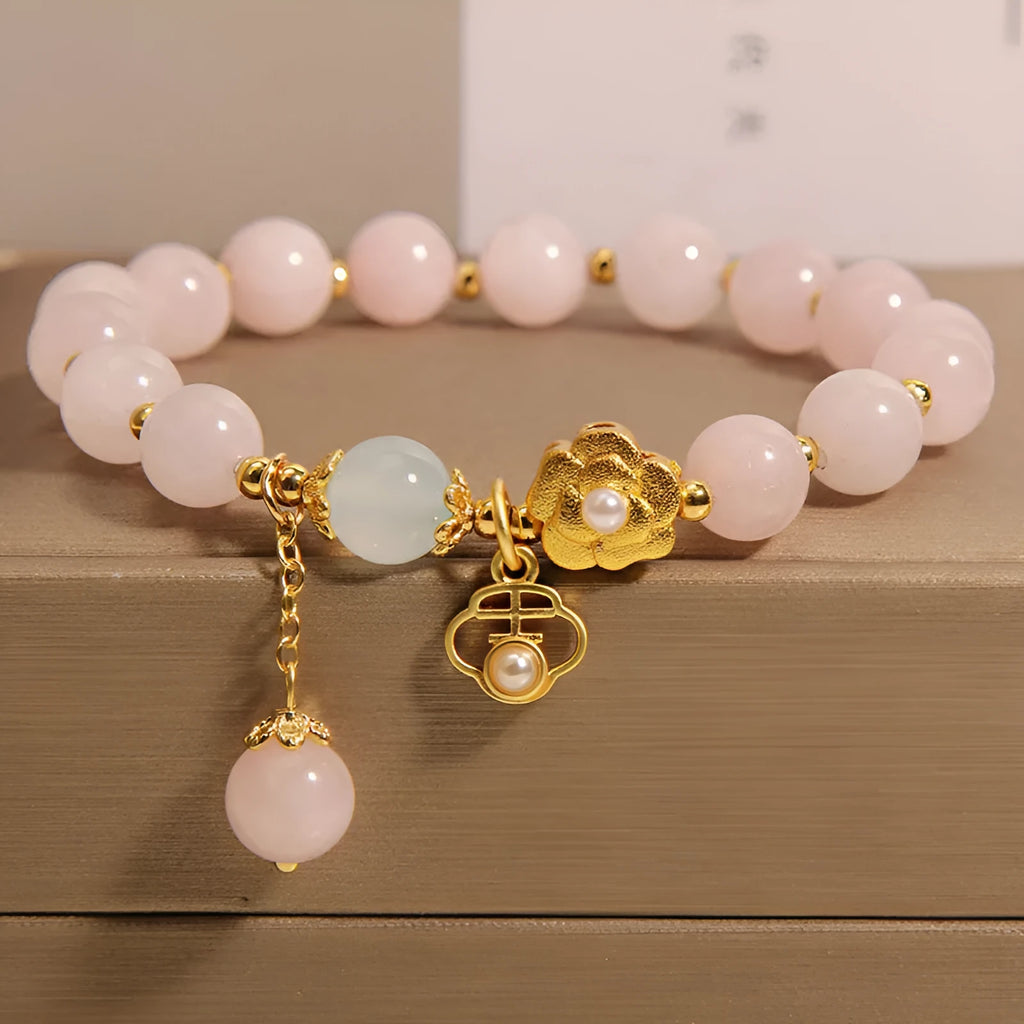 Close-up of a women's pink crystal flower bracelet on an adjustable chain.