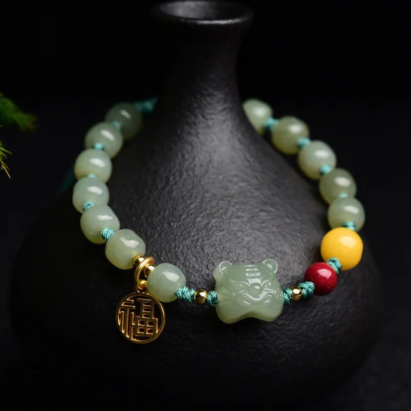 Natural Hetian Jade bracelet with cinnabar and beeswax beads in animal zodiac design.