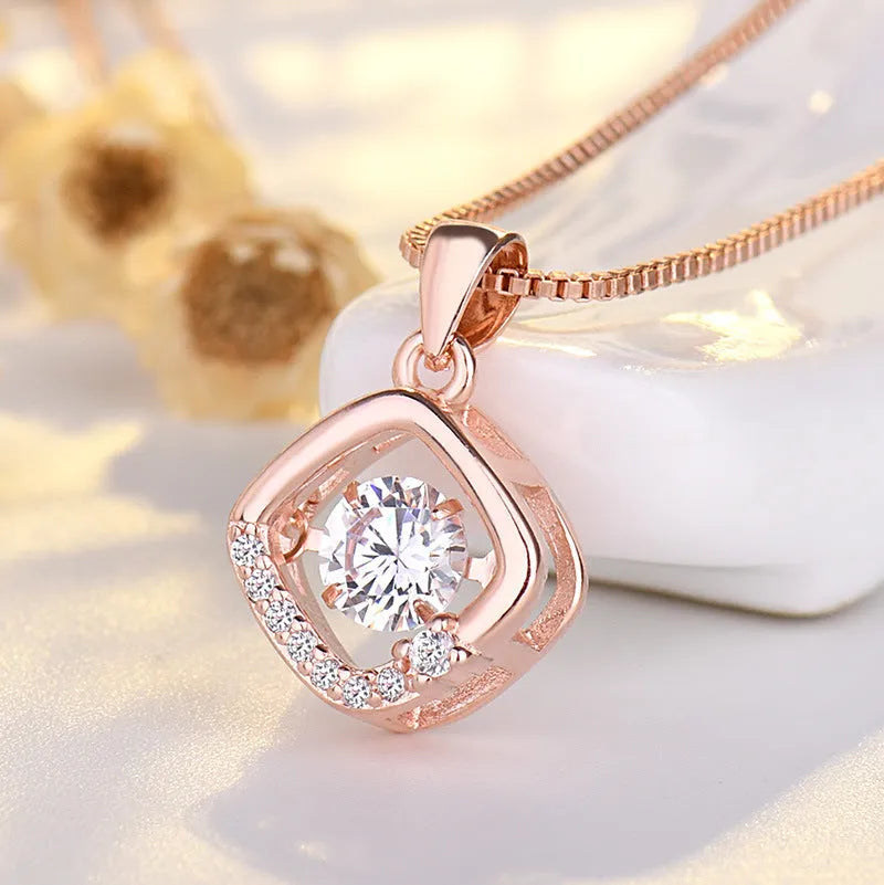 Women's sterling silver love heart necklace with crown and bow details on pendant