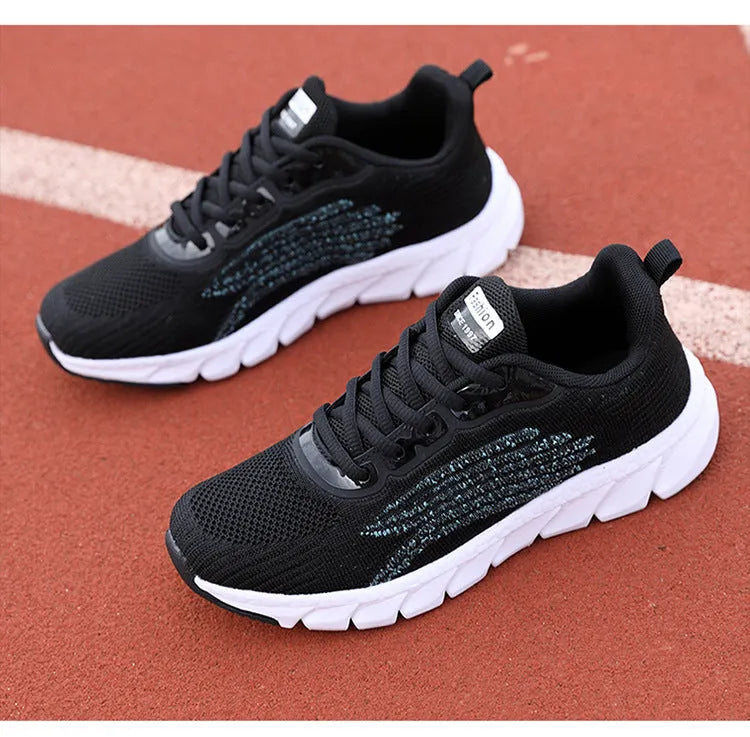 Women's low-top black and white running sneakers with cross-strap detail and MD sole.
