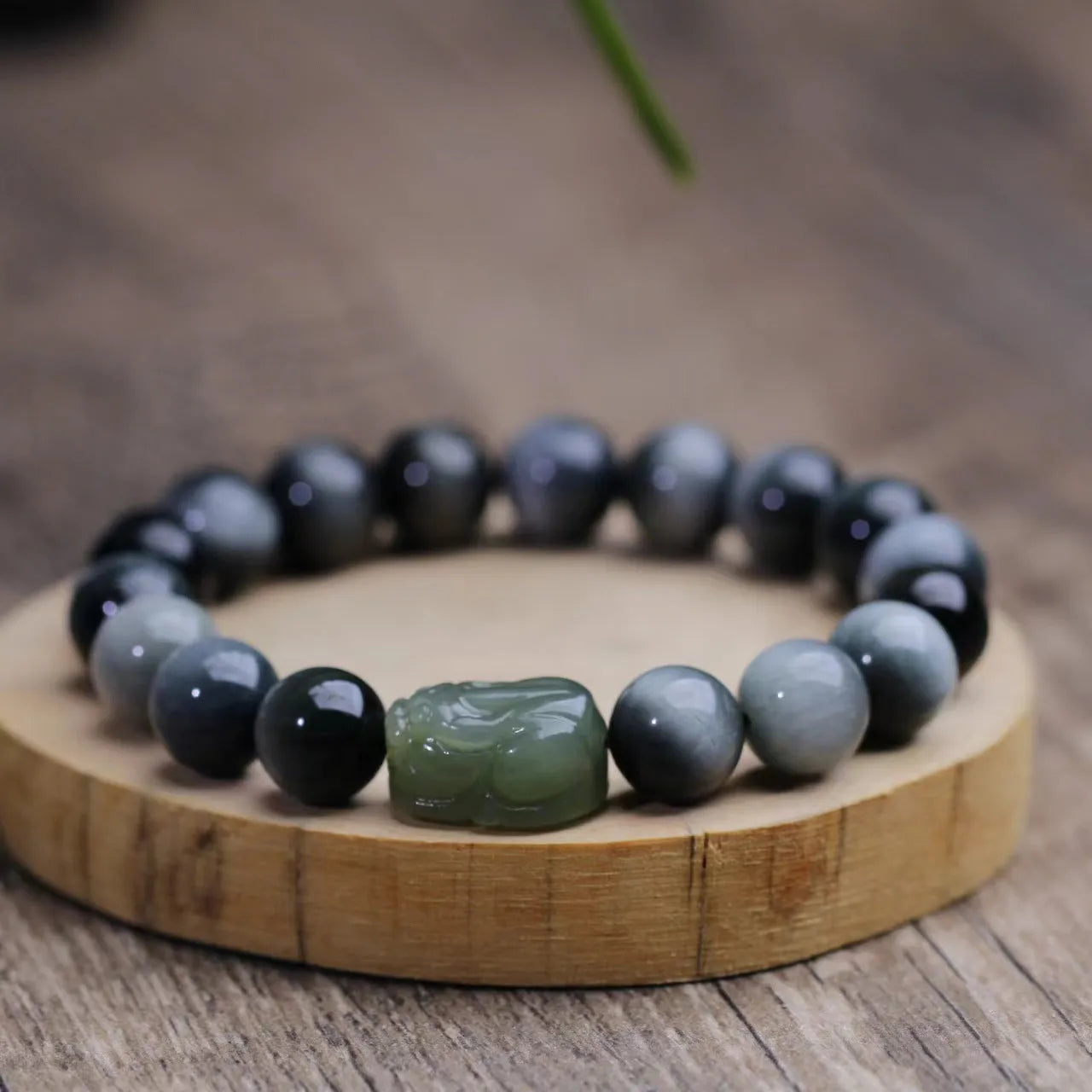 10mm Eagle Eye Stone bead bracelet with a natural Hetian Jade Clear Water Pixiu charm on a black cord.