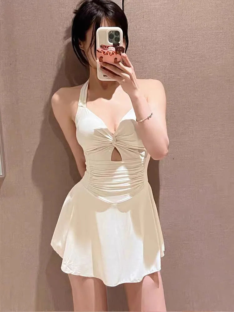 Women's solid colour conservative one-piece swimsuit with backless design