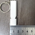 Silver and gold aluminium alloy outdoor survival whistle with double hole design.