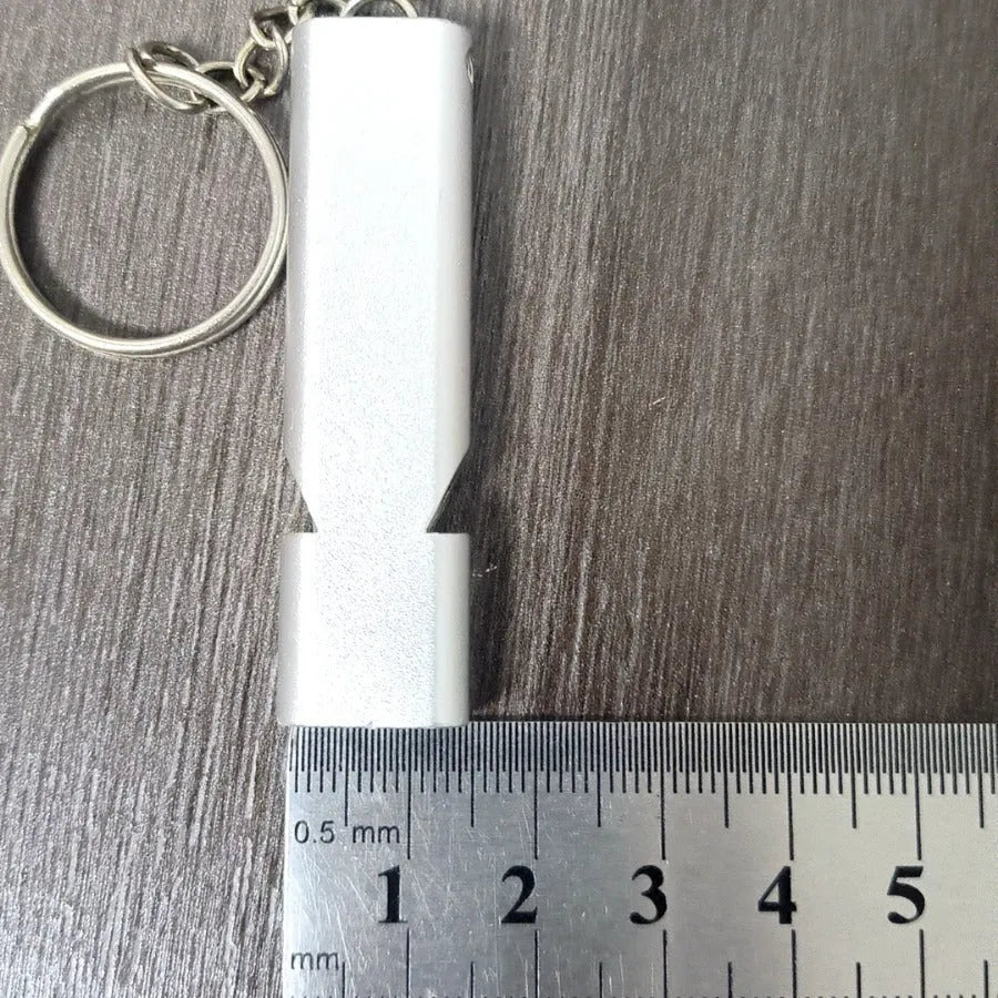 Silver and gold aluminium alloy outdoor survival whistle with double hole design.