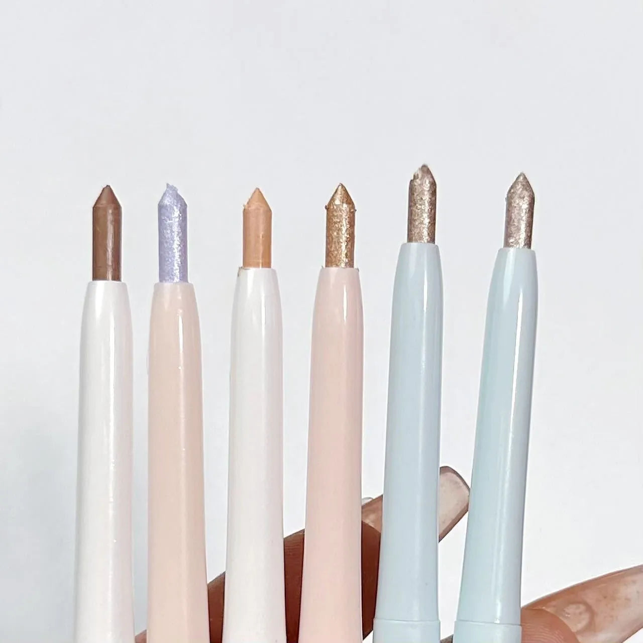 Waterproof and sweat-proof 2-in-1 eyeliner pen showing range of 15 colour shades including gold, purple, silver and brown
