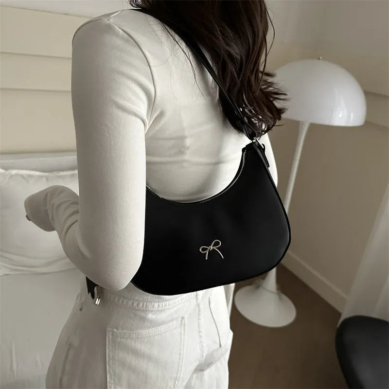 Small dumpling-shaped PU leather women's shoulder bag in khaki with a single strap and zip closure.