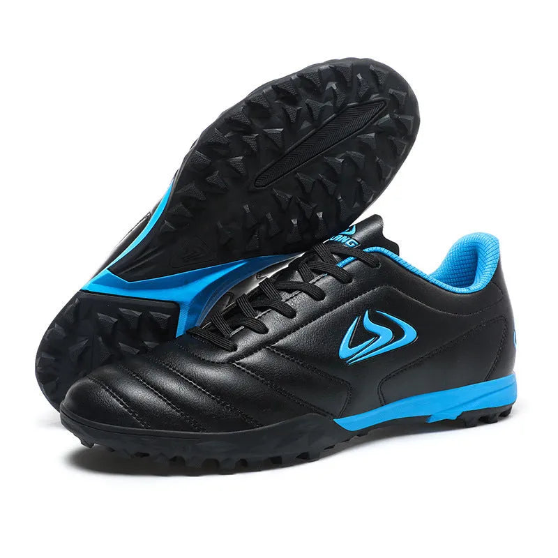 Low top football shoes with synthetic leather upper and rubber sole in black and white broken nails colour.