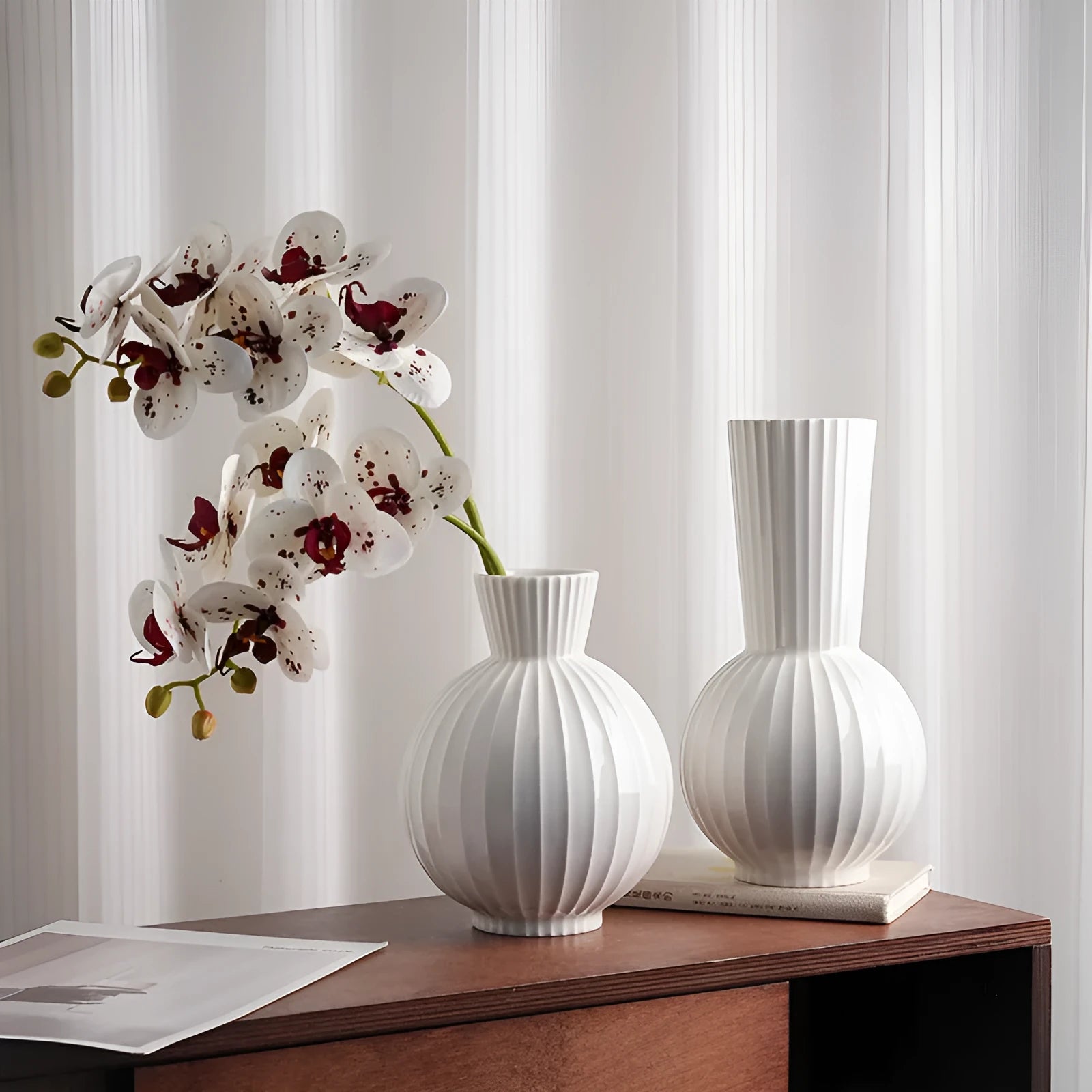 White ceramic vase with blue stripes in ball shape on wooden table