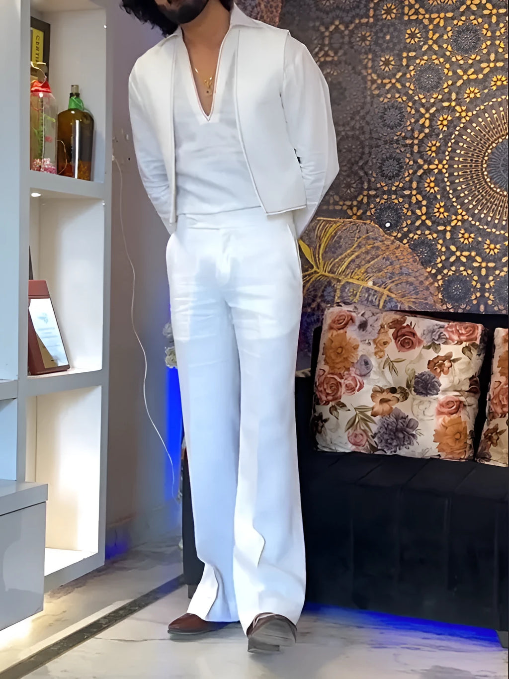 White three-piece outfit set showing V-neck shirt, sleeveless vest, and trousers laid flat