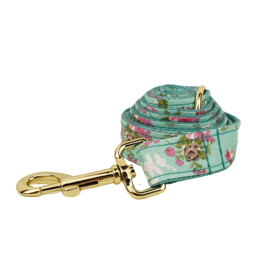 Rose pattern fabric dog collar set with green background including collar, leash, and detachable bow