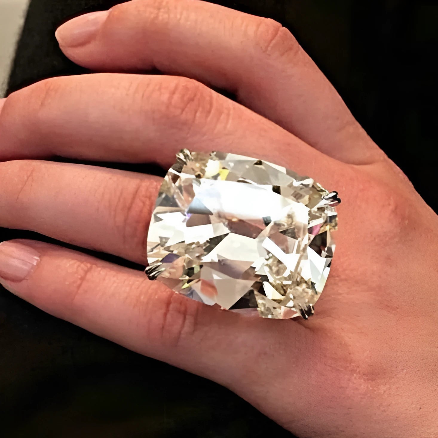 A women's simple inlaid white square diamond ring with a geometric shape and white gold colour finish.