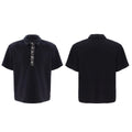 Men's black loose-fit short sleeve polo t-shirt with square collar and heavy embroidery sequin pattern detail.