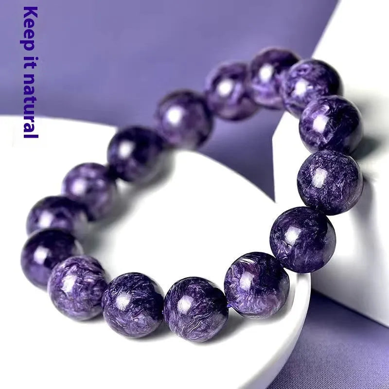 Natural transparent charoite crystal bracelet with platinum metal setting, showing different bead size options.
