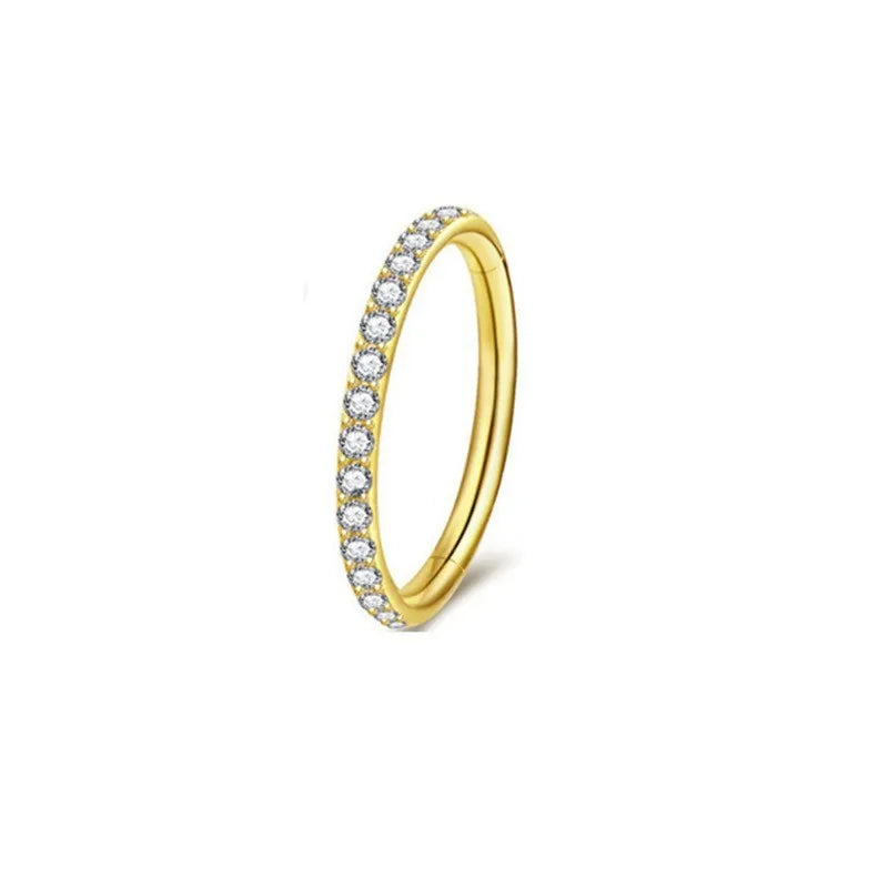 A stainless steel seamless nose ring with a diamond setting, shown in gold, rose gold, black, and steel finishes.
