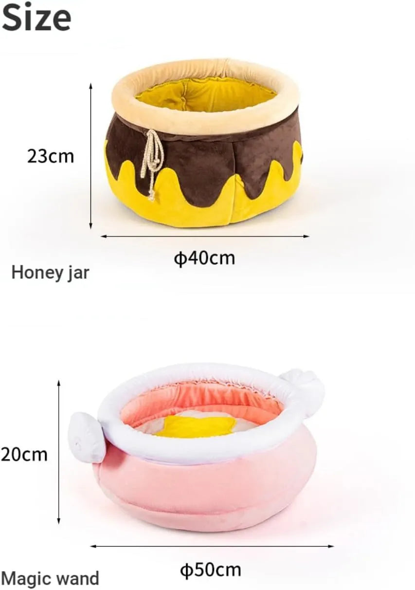 A pink magic honey pot shaped cat sofa bed with a soft interior for a small pet.