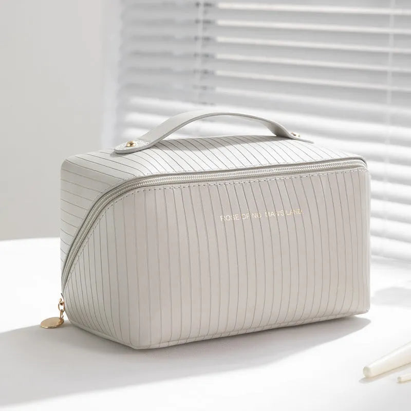 Vertical pattern pillow makeup bag in PU leather with cubic 22.5cm dimensions for travel storage