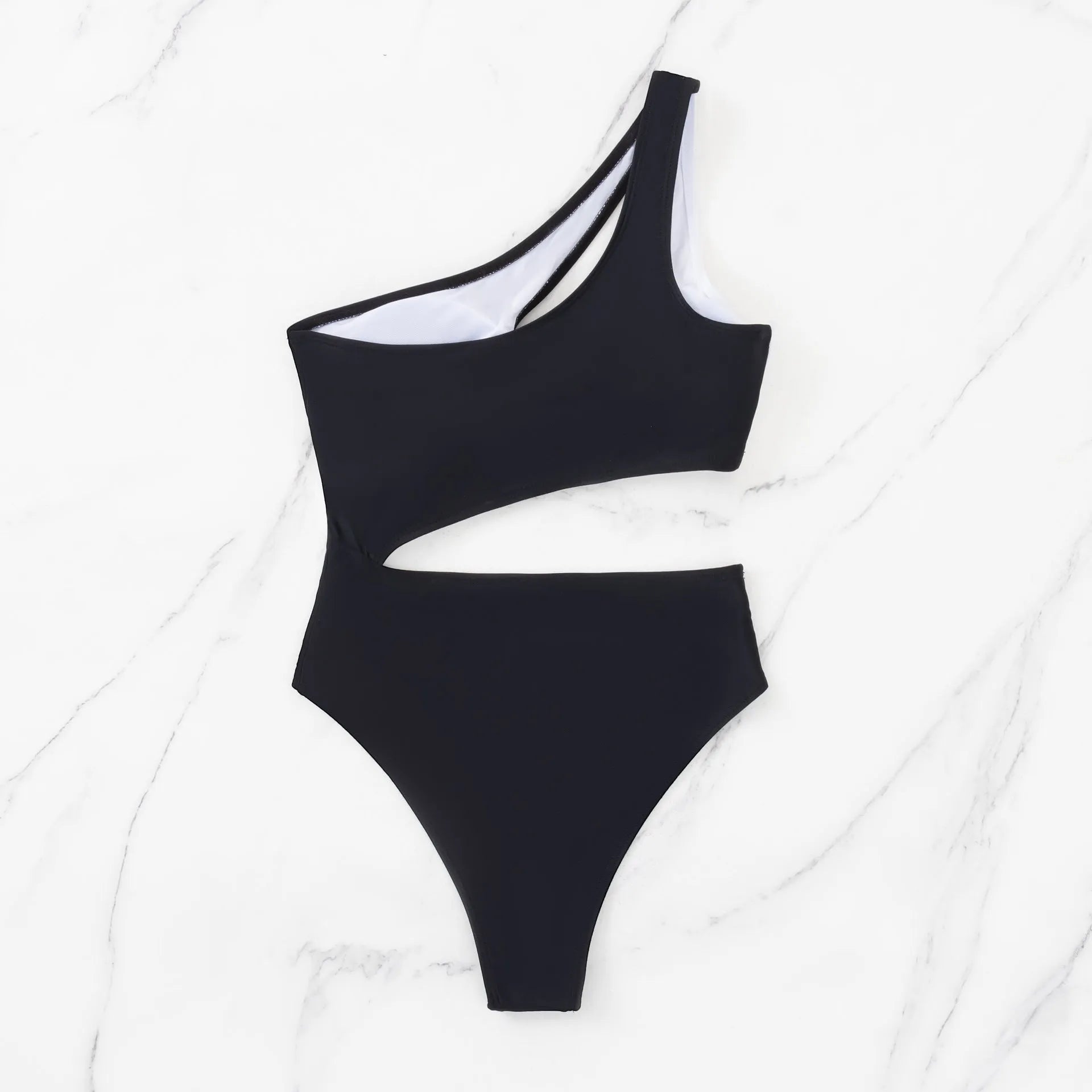 Black women's one-piece swimsuit with white contrast stitching and hollow cut-out design on a mannequin