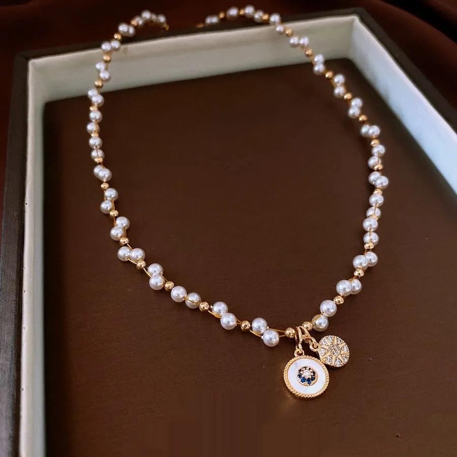 Gold electroplated necklace with round imitation pearl pendant and zircon accents on 41-50cm clavicle chain