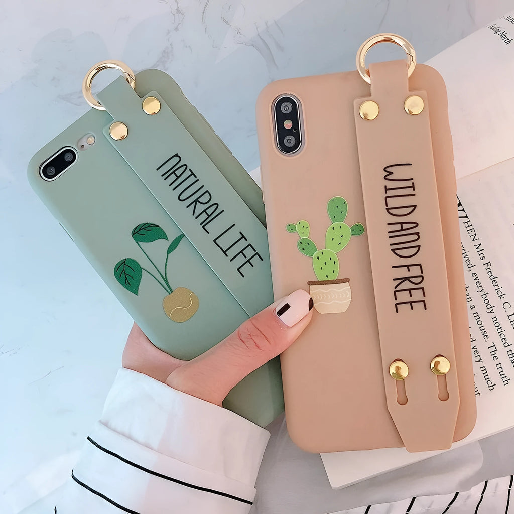 Green graffiti design wristband holder phone case for iPhone on a table.