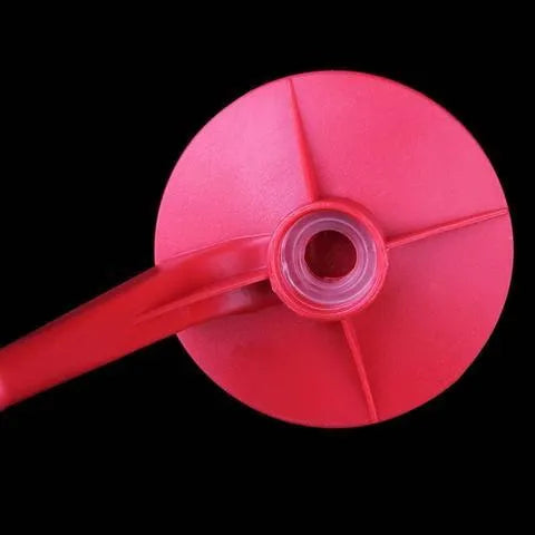 Red plastic Magic Tap soda dispenser attached to 2-litre bottle