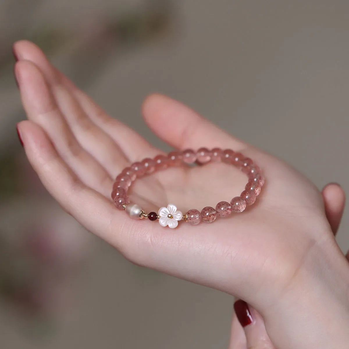 Strawberry quartz peach blossom crystal bracelet with floral design and adjustable cord