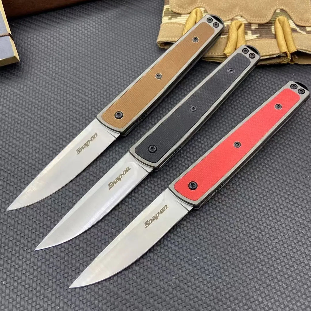 CRKT 7190 folding fruit knife with stainless steel blade shown closed and open, in black, brown, or red colour options.