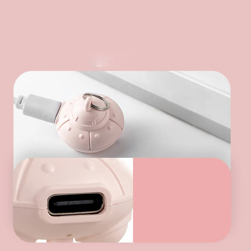 Green cat collar with attached small laser toy unit showing USB charging port.