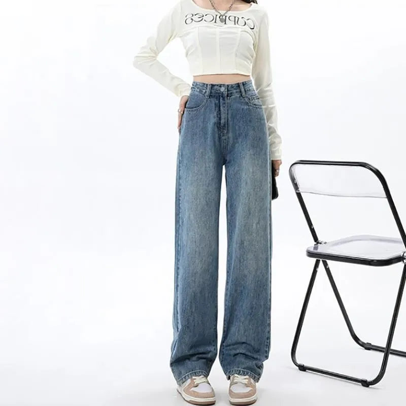 Retro blue high-waist wide leg jeans on a hanger showing straight leg trouser cut.
