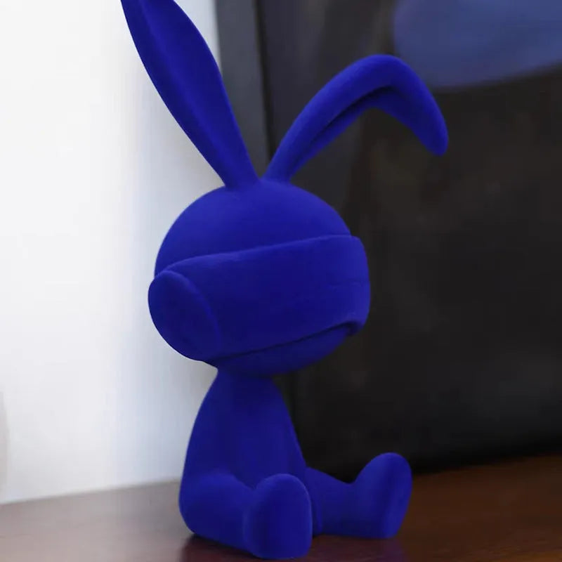 Resin rabbit table ornament with a suede blindfold in green, blue, or red colour options.