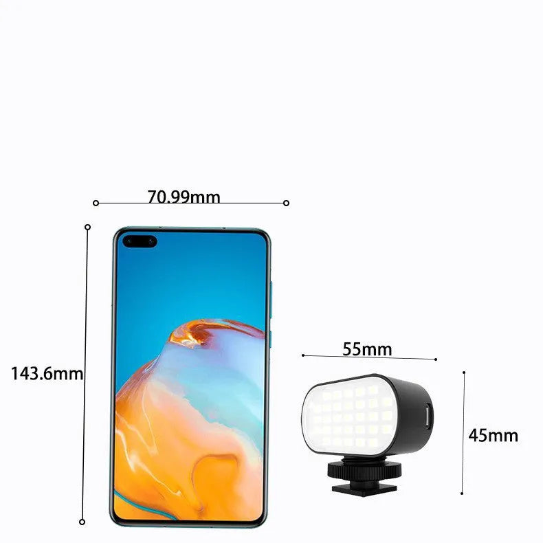 ST-30 black mobile phone fill light with digital display, mounted on a cold shoe next to six coloured photography palettes.