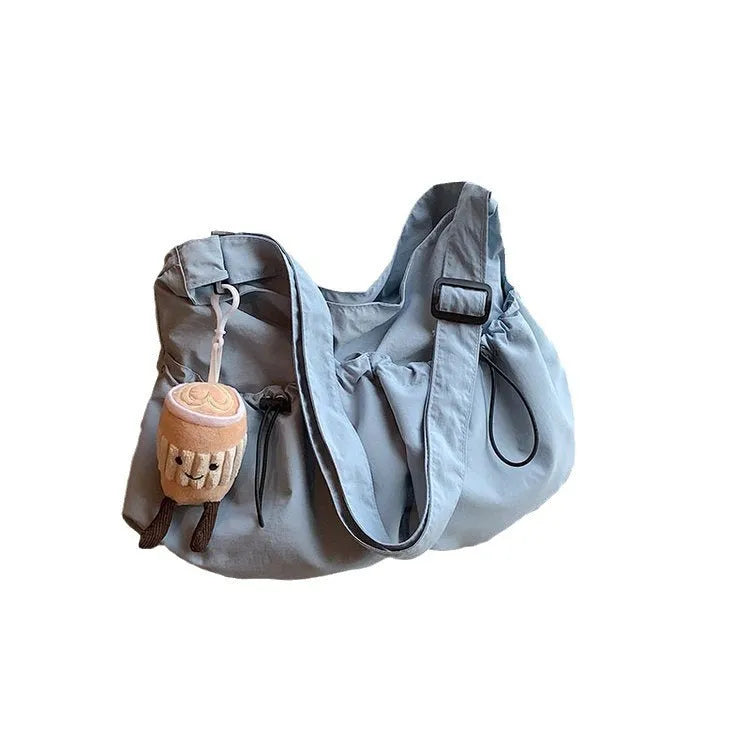 Green ultra-light pleated polyester crossbody bag with a split pocket, shown folded and open.