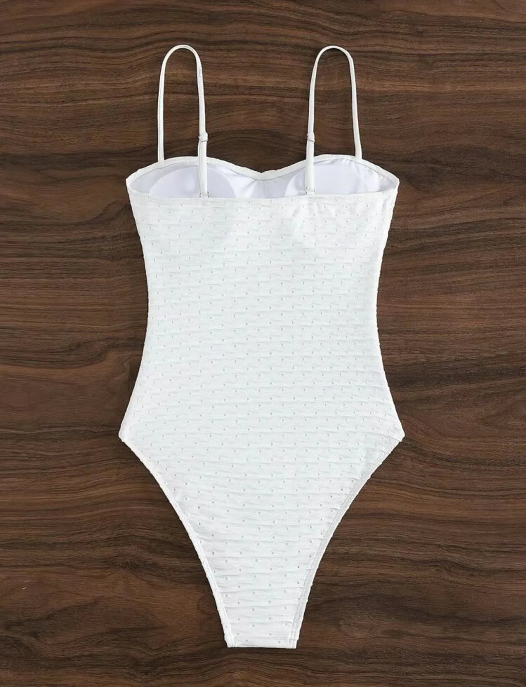 White one-piece women's swimsuit with sling straps and brief styling on mannequin
