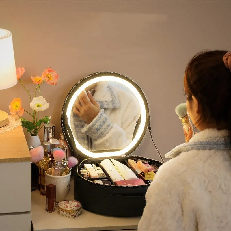 Round black PU leather makeup bag with open lid showing internal LED mirror and cosmetic partitions.