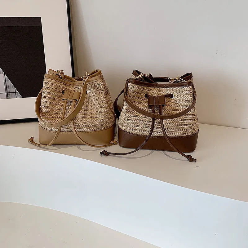 Woven straw women's crossbody bucket bag in horizontal square shape with adjustable shoulder strap